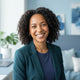 A professional portrait of a smiling woman looking at the camera, representing a happy, satisfied customer.